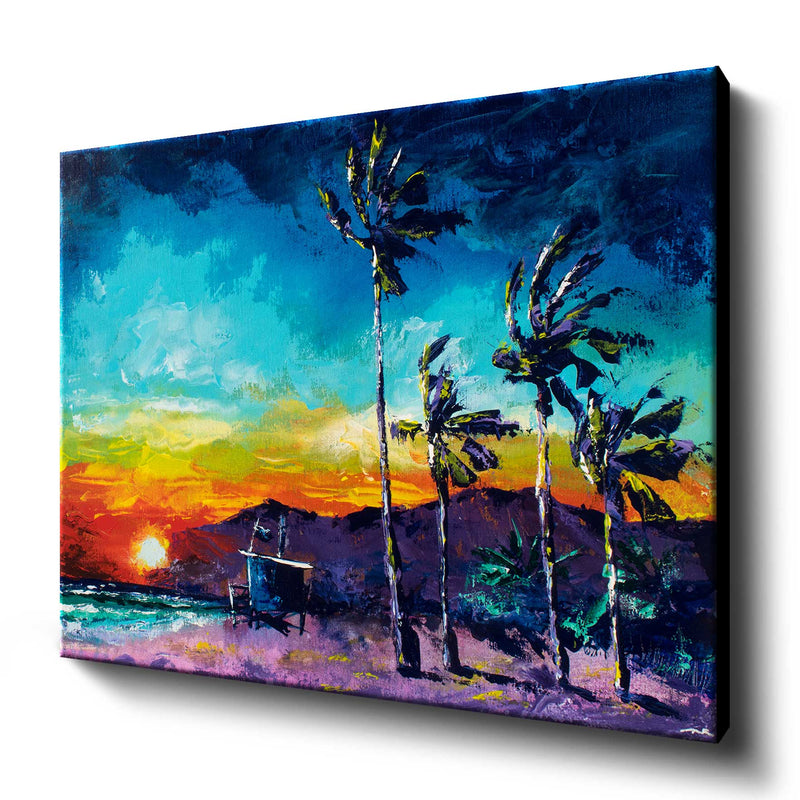Large canvas wall art of a surfing beach with blowing palm trees against a colorful sunset