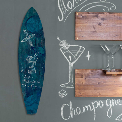 Handmade blue and green surfboard with white details hanging on a bar wall with a surf and tiki theme