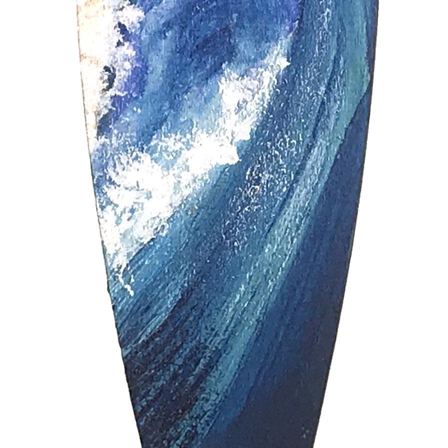 Navy blue Christmas ornament with a hand-painted ocean wave for beach Christmas tree decor.