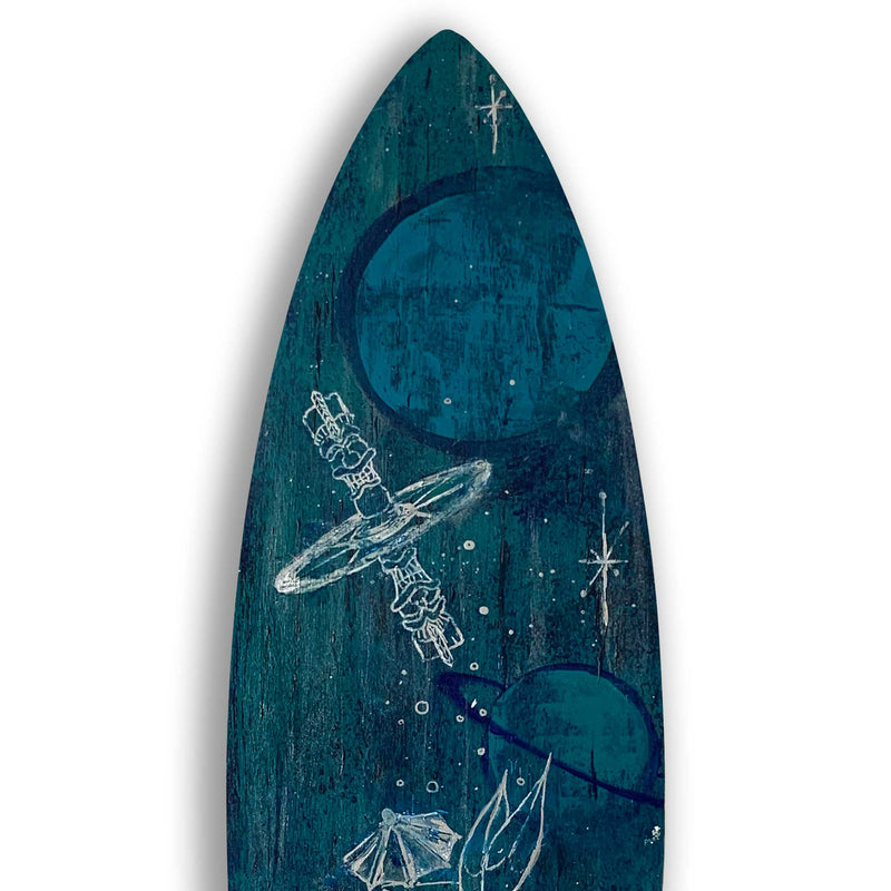 Closeup shot of a tiki-space themed surfboard painted in blues, turquoise, and greens with white details