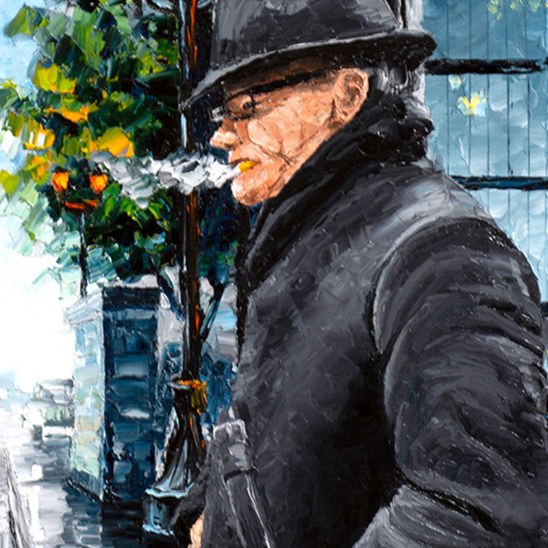 Travel wall art of a man walking through a snowy cityscape in the winter. His breath is visible against the skyline.