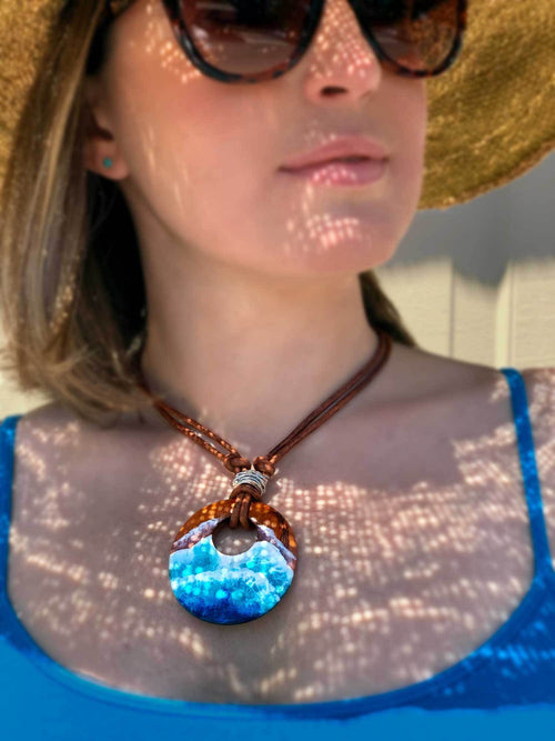 Handmade wood surfer jewelry for beach wear and tropical wedding. Round wood pendant with painted turquoise waves.